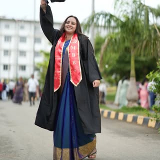 Dr. S Sanjana Devi at her MBBS convocation in gown and stole, tossing her graduation cap